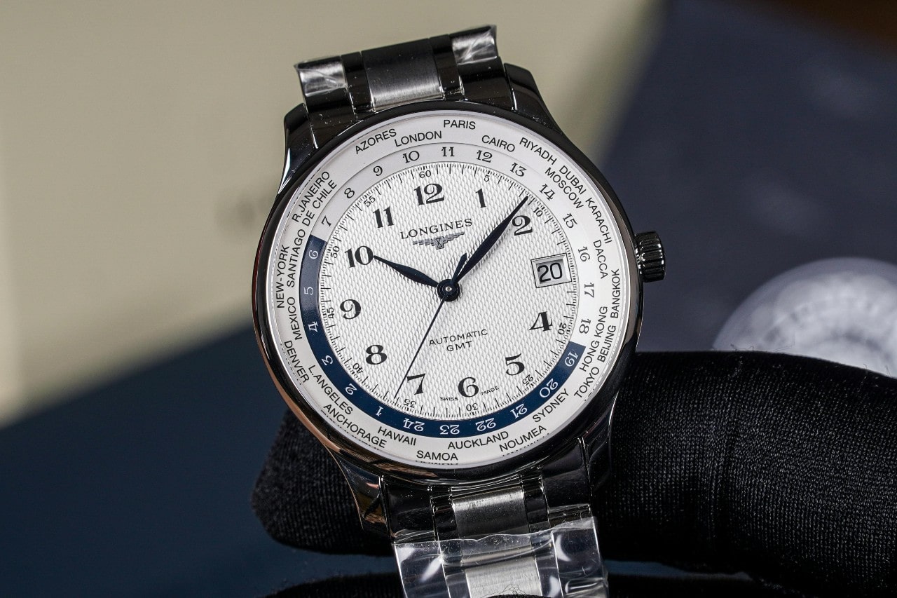 A close-up of an elegant Longines watch with multiple time zones.