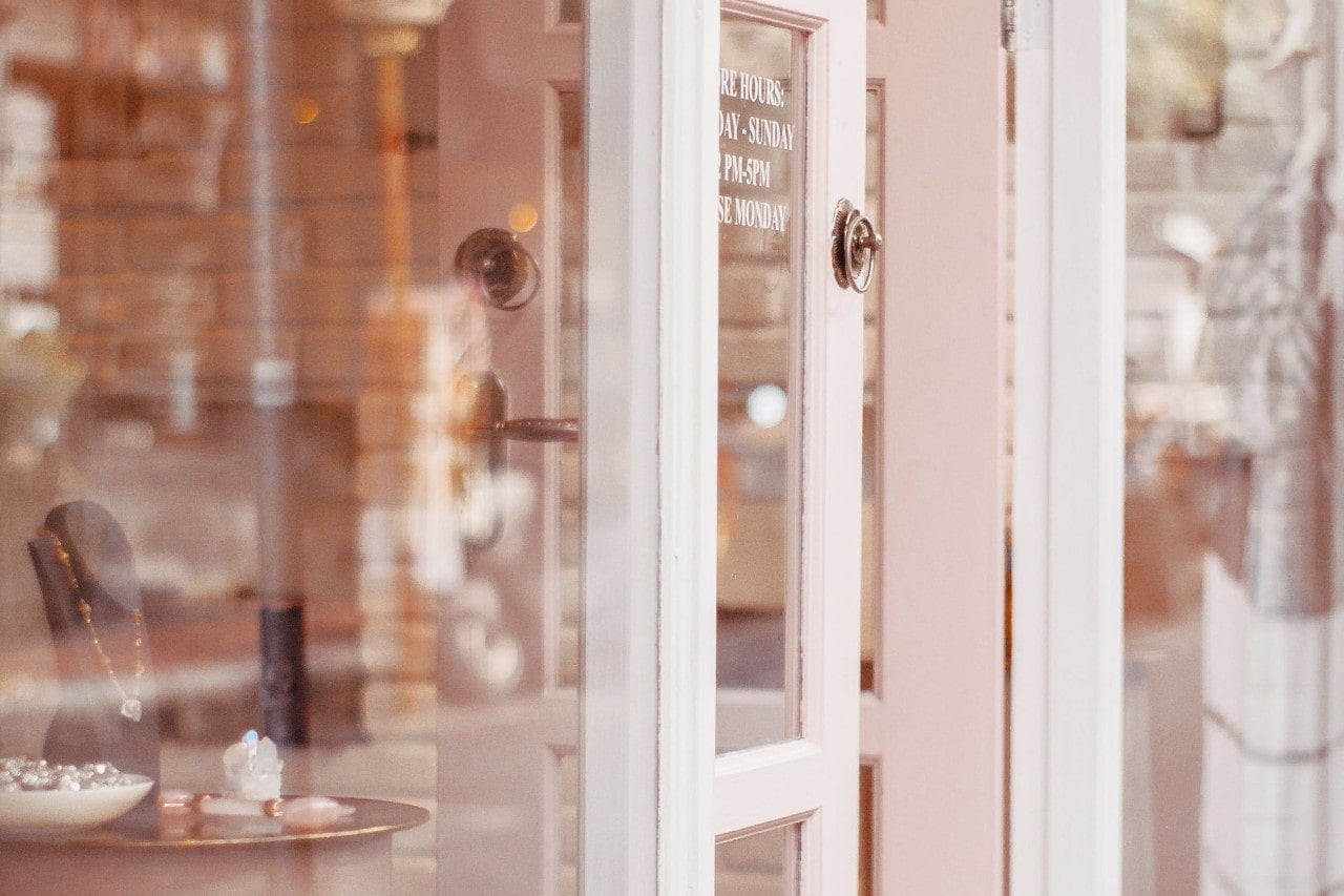 a picture taken outside of a jewelry store looking in through the front door and window