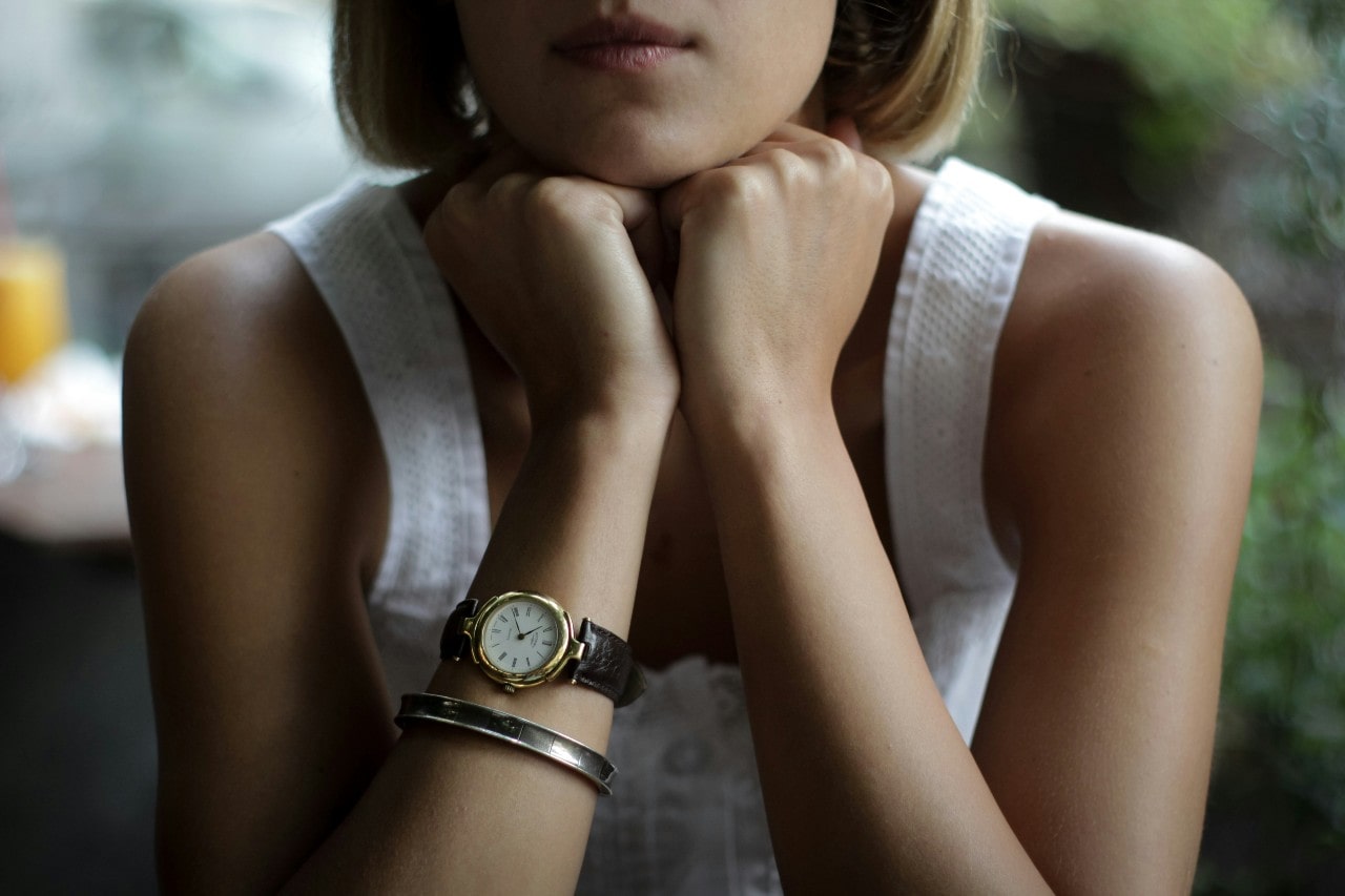 a lady wearing an elegant watch and bracelet